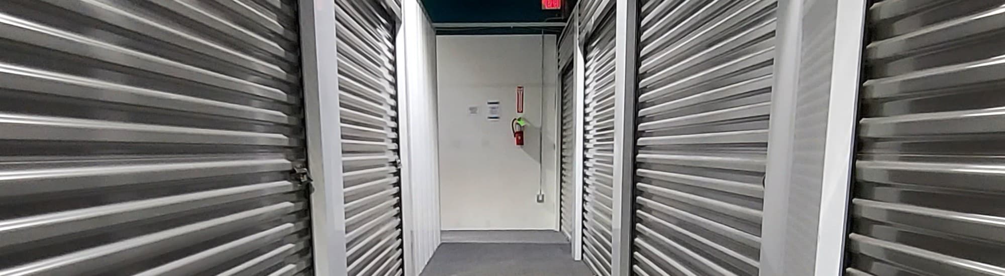Interior hallway of temperature-controlled storage units with roll-up doors